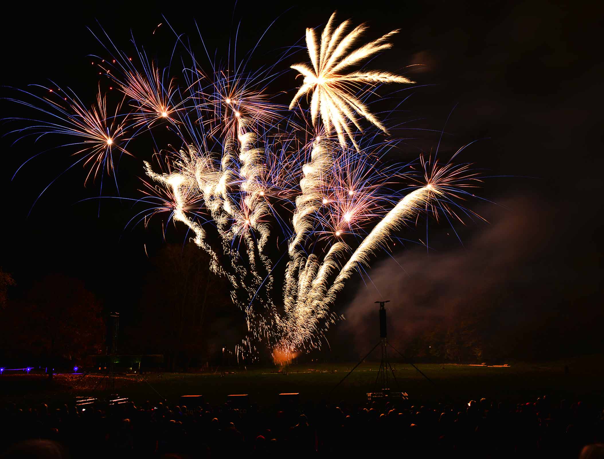The fireworks crew preparing a display at dusk